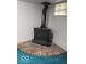 Basement with brick hearth and wood-burning stove at 4013 N Audubon Rd, Indianapolis, IN 46226