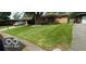 Brick ranch home with a large green lawn and driveway at 4013 N Audubon Rd, Indianapolis, IN 46226