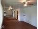 Spacious living room with mirrored wall and brown carpet at 4013 N Audubon Rd, Indianapolis, IN 46226