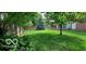 Large backyard with spacious lawn, mature trees, and shed at 4013 N Audubon Rd, Indianapolis, IN 46226