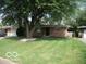 Brick ranch home with a tree and well-maintained lawn at 4013 N Audubon Rd, Indianapolis, IN 46226
