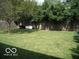 Spacious backyard with a grassy area and wooden fence at 4013 N Audubon Rd, Indianapolis, IN 46226