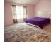 Spacious bedroom with plush carpet, large bed, and window with curtains at 11613 Coastal Dr, Indianapolis, IN 46229