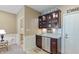Basement wet bar with granite countertop and mini fridge at 2495 Glebe St, Carmel, IN 46032