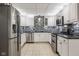 Modern basement kitchen with stainless steel appliances and white cabinets at 5181 S Poplar Dr, Columbus, IN 47201