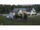 White brick ranch house with landscaped yard at dusk at 5181 S Poplar Dr, Columbus, IN 47201