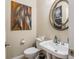 Clean bathroom with a sink, toilet, and decorative mirror at 5181 S Poplar Dr, Columbus, IN 47201