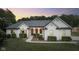 Luxury white brick home with manicured lawn at dusk at 5181 S Poplar Dr, Columbus, IN 47201