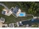 Aerial view showcasing a house, pool, and dock on a tranquil waterfront setting at 5181 S Poplar Dr, Columbus, IN 47201