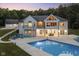 Luxury home with pool and deck, beautifully lit at dusk at 5181 S Poplar Dr, Columbus, IN 47201