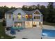 Two-story white brick house with pool and patio at dusk at 5181 S Poplar Dr, Columbus, IN 47201