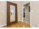 Light-filled hallway with hardwood floors and a large mirror at 5181 S Poplar Dr, Columbus, IN 47201
