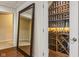 Walk-in wine cellar with extensive shelving and glass door at 5181 S Poplar Dr, Columbus, IN 47201