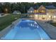 Bright blue rectangular pool with house reflection at night at 5181 S Poplar Dr, Columbus, IN 47201