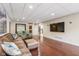 Finished basement with hardwood floors, leather furniture, and large screen TV at 5181 S Poplar Dr, Columbus, IN 47201