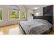 Main bedroom with hardwood floors and large windows offering wooded views at 5181 S Poplar Dr, Columbus, IN 47201