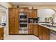 Modern kitchen with stainless steel appliances and ample wood cabinetry at 5181 S Poplar Dr, Columbus, IN 47201