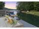 Peaceful lakeside patio with colorful chairs and dock at 5181 S Poplar Dr, Columbus, IN 47201