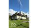 Two-story house, light beige siding, gabled roof and small yard at 3302 Columbus Ave, Anderson, IN 46013