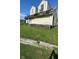 Two-story house, light beige siding, gabled roof and small yard at 3302 Columbus Ave, Anderson, IN 46013
