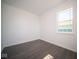 Simple bedroom with vinyl plank flooring and large window at 1402 Foxtail Ln, Greenwood, IN 46143