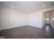 Open living room with vinyl plank flooring and access to entry at 1402 Foxtail Ln, Greenwood, IN 46143