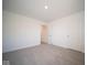 Bright bedroom with carpet, door, and hallway access at 1402 Foxtail Ln, Greenwood, IN 46143