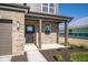 Brick house exterior with front porch and landscaping at 1402 Foxtail Ln, Greenwood, IN 46143
