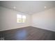 Empty bedroom with vinyl plank flooring and window at 1402 Foxtail Ln, Greenwood, IN 46143