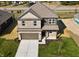 Two-story house with a two-car garage and landscaped yard at 1402 Foxtail Ln, Greenwood, IN 46143