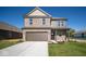 Two-story brick home with a brown garage door and landscaped lawn at 1402 Foxtail Ln, Greenwood, IN 46143