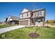 Two-story brick home with brown garage door and landscaped lawn at 1402 Foxtail Ln, Greenwood, IN 46143