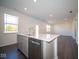 Kitchen island with sink, dishwasher and stainless steel appliances at 1402 Foxtail Ln, Greenwood, IN 46143