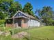 Gray sided home with a covered porch and chain link fence at 2221 Langley Ave, Indianapolis, IN 46218