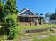 Brick and gray sided home with a covered porch at 2221 Langley Ave, Indianapolis, IN 46218