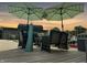Relaxing deck with patio furniture and umbrellas at sunset at 5647 W Mooresville Rd, Indianapolis, IN 46221