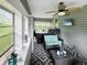 Relaxing enclosed porch with hot tub, seating area, and large windows at 5647 W Mooresville Rd, Indianapolis, IN 46221