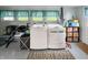 Bright laundry room features washer, dryer, and extra storage at 5647 W Mooresville Rd, Indianapolis, IN 46221