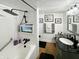Modern bathroom with black vanity, shower, and bathtub at 5647 W Mooresville Rd, Indianapolis, IN 46221
