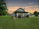 Charming one-story home with a well-maintained lawn and sunset view at 5647 W Mooresville Rd, Indianapolis, IN 46221