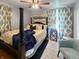 Bedroom with a post bed, ceiling fan, and sitting chair at 5647 W Mooresville Rd, Indianapolis, IN 46221