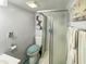 Small bathroom with shower, toilet, and updated vanity at 5647 W Mooresville Rd, Indianapolis, IN 46221
