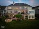 Back of luxury home with a patio, pergola, and fire pit at 9088 Nautical Watch Dr, Indianapolis, IN 46236