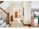 Spacious entry hall with wood staircase and views into the kitchen at 9088 Nautical Watch Dr, Indianapolis, IN 46236