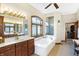 Bathroom with a large soaking tub, double vanity, and stained-glass window at 9088 Nautical Watch Dr, Indianapolis, IN 46236