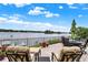 Spacious deck with lake view, seating, and umbrella at 9088 Nautical Watch Dr, Indianapolis, IN 46236