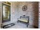 Brick front porch with a metal bench and decorative wall art at 9088 Nautical Watch Dr, Indianapolis, IN 46236