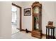Hallway with grandfather clock, framed art and a small dog at 9088 Nautical Watch Dr, Indianapolis, IN 46236