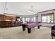 Basement game room with pool table, wet bar, and lake views at 9088 Nautical Watch Dr, Indianapolis, IN 46236