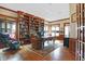 Spacious home office with built-in bookshelves, large desk, and hardwood floors at 9088 Nautical Watch Dr, Indianapolis, IN 46236